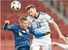  ?? Reuters ?? Scotland’s Liam Cooper with Slovakia’s Lubomir Satka during their match.