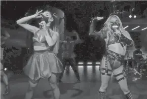  ?? MTV ?? Ariana Grande, left, wears a mask while performing with Lady Gaga, right, during the MTV Video Music Awards in August.