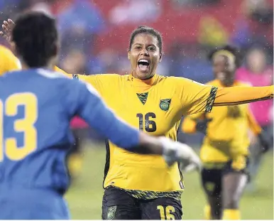  ??  ?? Reggae Girlz defender Dominique Bond-Flasza runs to goalkeeper Nicole McClure after hitting the winning penalty kick to defeat Panama in the third-place match of the CONCACAF women’s World Cup qualifying tournament in Frisco, Texas, on Wednesday.