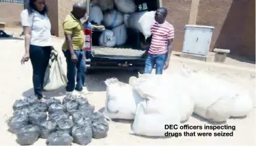  ??  ?? DEC officers inspecting drugs that were seized