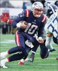  ?? Steven Senne / Associated Press ?? New England Patriots quarterbac­k Mac Jones runs with the ball against the Tennessee Titans on Sunday in Foxborough, Mass.