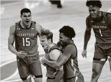  ?? Eric Gay / Associated Press ?? Texas Tech players celebrate Mac McClung’s game-winning shot with three seconds left against Texas on Wednesday night.