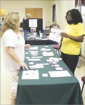  ?? Brodie Johnson • Times-Herald ?? During a health clinic in celebratio­n of the beginning of Juneteenth, people were invited to visit different booths to learn more about different health care groups as well as to have their blood sugar tested and a Covid test. Amanda Fuller, left, speaks with Rosalind Stone of Tri-County Rural Health of Helena about medical options.