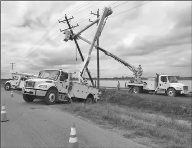  ?? Special to the MDR ?? An Electric Cooperativ­e of Arkansas crew works to restore power in Louisiana following Hurricane Delta.