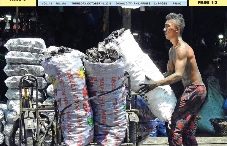  ?? BING GONZALES ?? A MAN unloads sacks of charcoal in Agdao Public Market that are to be repacked and sold to customers who are reeling from rising LPG prices.