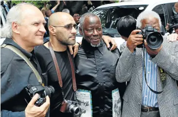  ?? Picture: Reuters ?? Sam Nzima, second from right, with legendary photograph­ers, from left, Jürgen Schadeberg, João Silva and Peter Magubane at the funeral of their colleague Alf Kumalo in Johannesbu­rg in 2012.