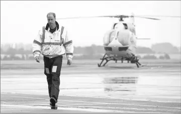  ?? — Reuters file photo ?? Prince William walks away from his helicopter as he begins his new job as a co-pilot with the East Anglia Air Ambulance at Cambridge Airport, Britain on July 13, 2015.