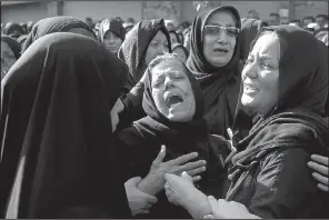  ?? AP/EBRAHIM NOROOZI ?? Families of victims of Saturday’s terror attack on an Iranian military parade that killed 25 people mourn at a mass funeral ceremony Monday in Ahvaz, Iran.