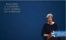  ?? CARL COURT/GETTY IMAGES ?? Letters begin to fall off the backdrop as U.K. Prime Minister Theresa May delivers her keynote speech at the Conservati­ve Party Conference.