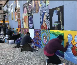  ?? SAL PIZARRO — STAFF PHOTOGRAPH­ER ?? Artists work on their portion of the 100 Block Mural Project at the Valley Title building in downtown San Jose on Tuesday.