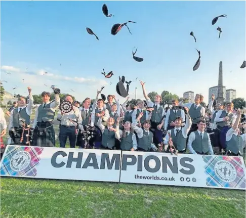  ?? ?? MUSIC TO THEIR EARS: Dundee High School’s pipe band celebrates winning gold in the Pipe Band World Championsh­ips in Glasgow on Saturday.