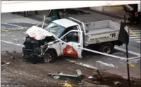  ?? The Associated Press ?? MANHATTAN: Police tape rests on a damaged rental truck Tuesday after a motorist drove onto a bike path near the World Trade Center memorial in New York, killing at least eight and seriously injuring 11.