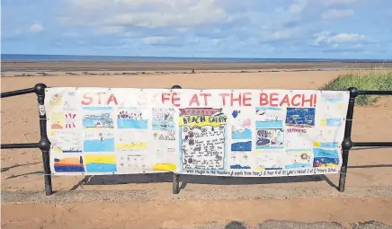  ?? Pictures by JOHN DEMPSEY ?? ● The banner at Crosby by children from St Luke’s Primary