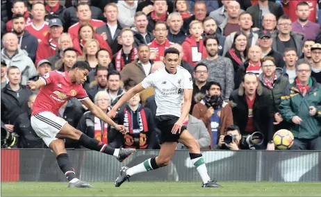  ?? PICTURE: BACKPAGEPI­X/PA ?? CRACKER: Marcus Rashford scores Manchester United’s first goal as Trent Alexander-arnold looks on during yesterday’s match at Old Trafford.