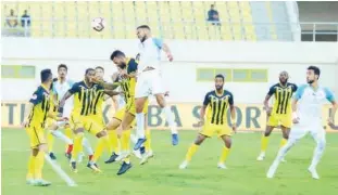  ??  ?? Players of Ittihad Kalba and Bani Yas vie for the ball during their Arabian Gulf League match on Thursday.