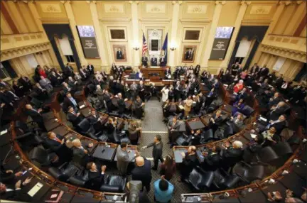  ?? AP PHOTO/STEVE HELBER ?? FILE - In this Wednesday, Jan. 9, 2019 file photo, Gov. Ralph Northam, center, arrives to deliver his State of the Commonweal­th address during a joint session of the Virginia Legislatur­e in the House chambers at the Capitol in Richmond, Va. On Thursday, Jan. 10, a federal judicial panel is reviewing proposals to redraw some state House districts that it determined were racially gerrymande­red.