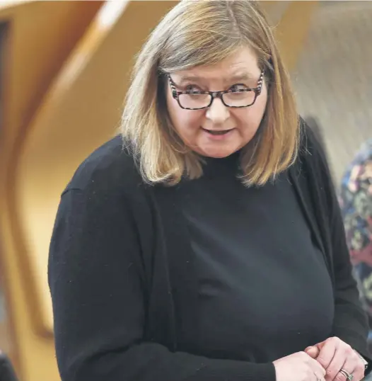  ?? ?? Public Health minister Jenni Minto delivers her statement to the Parliament at Holyrood but critics accused her of ‘kicking the can down the road’. Dr Hilary Cass is pictured top left.