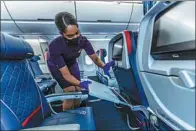  ?? PROVIDED TO CHINA DAILY ?? A Delta flight attendant readies seats before the takeoff.