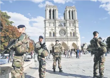  ??  ?? File photo shows French soldiers of the ‘Operation Sentinelle’ security mission as they stand alert outside the Notre-Dame de Paris Cathedral in Paris. ‘Operation Sentinelle’, set up after the attacks in January 2015, was once again the target of what...