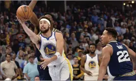  ?? BRANDON DILL — THE ASSOCIATED PRESS ?? Warriors guard Klay Thompson (11) shoots between Grizzlies forward Jaren Jackson Jr. and guard Desmond Bane (22) during Game 2of a second-round playoff series on Tuesday.