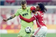  ?? AFP ?? Augsburg’s Daniel Baier (left) and Bayern’s Renato Sanches vie for the ball during their recent German Cup match. —