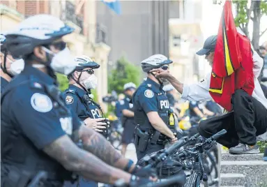  ?? COLE BURSTON GETTY IMAGES ?? A protester confronts a Toronto Police officer during an anti-racism march on June 6. With their new black uniforms, a group of Toronto police look somewhat like stormtroop­ers, Michael Forster of Toronto writes.