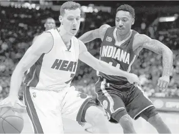  ?? MICHAEL LAUGHLIN/STAFF PHOTOGRAPH­ER ?? The Heat’s Goran Dragic is turned away by the Pacers’ Jeff Teague during the first half Saturday in Miami.