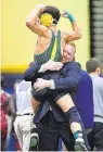  ?? STAFF FILE ?? Great Bridge’s Brandon Morales celebrates with coach Matt Small after winning a Class 4 126-pound state championsh­ip in 2019.