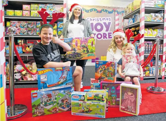  ?? Photo / Alex Burton ?? Max Page, 10, store founder Sarah Page, Cecille Brunt and Lucca Brunt, 4, show off some of the toys at The Christmas Joy Store in Balmoral.