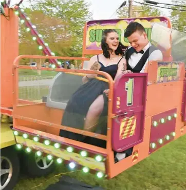  ?? JEFFREY F. BILL/BALTIMORE SUN MEDIA ?? Kaitlyn Frey and Hunter Griffith ride the “Super Sonic” at prom. Northeast High School’s 2022 Senior Prom at the Maryland Yacht Club in Pasadena was sponsored by the community, not the school.