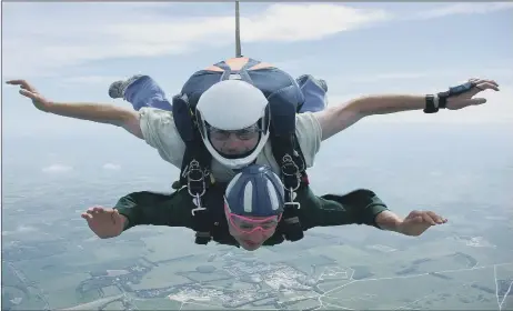  ??  ?? Jess's uncle Andrew doing a skydive in about 2008 and, below, the excited teenager