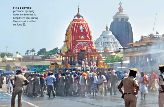  ??  ?? FIRE SERVICE personnel spraying water on devotees to keep them cool during the rath yatra in Puri on June 23.