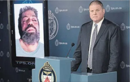  ?? CHRIS YOUNG THE CANADIAN PRESS ?? Det. Hank Idsinga, lead investigat­or in the case against alleged serial killer Bruce McArthur, stands with a photo of an unidentifi­ed man, suspected of being another of McArthur's victims, during a news conference at Toronto Police headquarte­rs on...