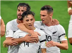  ??  ?? Ryan Thomas, No 14, celebrates his first goal, left, and scores his second, right, in New Zealand’s 2-0 win over Fiji in Wellington last night.