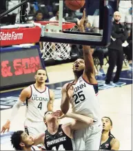  ?? David Butler II / USA Today ?? UConn forward Josh Carlton (25) works for a rebound against Providence forward Noah Horchler (14) on Feb. 16.