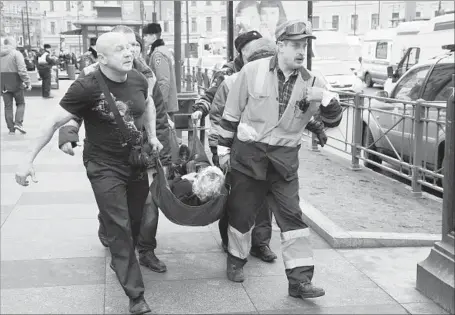  ?? Anton Vaganov European Pressphoto Agency ?? A VICTIM of the explosion near the Technologi­cal Institute station in St. Petersburg is carried away. Alexander Kurennoi of the General Prosecutor’s Office at first called the bombing a terrorist attack, but later said it was too early to draw any...