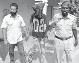  ?? PARDEEP PANDIT/HT ?? The accused in police custody in Jalandhar on Friday.