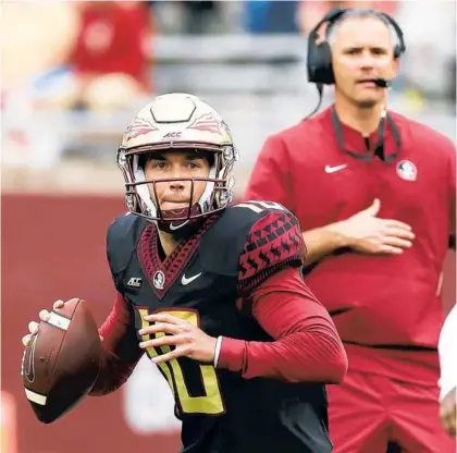  ?? STEPHEN M. DOWELL/ORLANDO SENTINEL ?? FSU head coach Mike Norvell watches quarterbac­k McKenzie Milton during the FSU Garnet & Gold Spring Game at Doak Campbell Stadium in Tallahasse­e on Saturday.