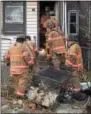  ?? PETE BANNAN – DIGITAL FIRST MEDIA ?? Coatesvill­e firefighte­rs remove damaged contents from the kitchen.