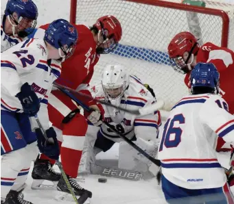  ?? JIM MICHAUD / BOSTON HERALD ?? HOLD THE LINE: Burlington goalie Joe Trabucco faces a barrage in the final seconds of the Red Devils 3-2 win over Hingham on Sunday. Trabucco finishes with 26 saves.