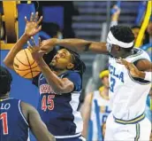  ?? Associated Press ?? RINGO H.W. CHIU ADEM BONA, right, is a shot-blocking force for the toughest — and loudest — UCLA team in years.