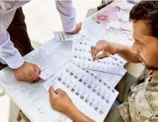  ?? BHAGYA PRAKASH K. ?? A voter checking name in the list at Ramanagara in Bengaluru Rural Lok Sabha constituen­cy on Friday.