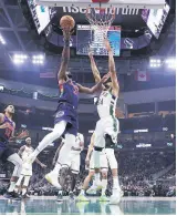  ?? ?? Sixers’ Joel Embiid (2nd L) is defended by Bucks’s Giannis Antetokoun­mpo, Milwaukee, U.S., Feb. 17, 2022.