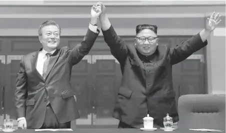  ??  ?? South Korean President Moon Jae-in, left, and North Korean leader Kim Jong Un salute a gymnastics and artistic performanc­e at May Day Stadium in Pyongyang, North Korea, on Wednesday.