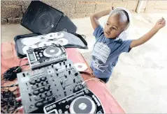  ??  ?? DJ Arch jn, then aged two, plays some hits outside his parents’ home in Klipspruit, Soweto. Now he’s trying for a Guinness World Record.