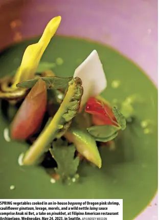  ?? AP/LINDSEY WASSON ?? SPRING vegetables cooked in an in-house bagoong of Oregon pink shrimp, cauliflowe­r ginataan, lovage, morels, and a wild nettle laing sauce comprise Anak ni Bet, a take on pinakbet, at Filipino American restaurant Archipelag­o, Wednesday, May 24, 2023, in Seattle.