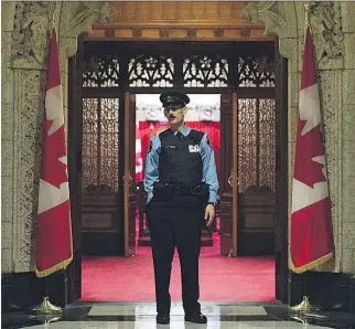  ?? SEAN KILPATRICK/ THE CANADIAN PRESS ?? While House of Commons guards are now armed, those at the Senate are not, as shown. An invisible line separates the areas of responsibi­lity within the Parliament Buildings.