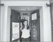  ?? PHOTOS BY JACQUELYN MARTIN — THE ASSOCIATED PRESS ?? University of Virginia Student Council President Sarah Kenny is among the students who have posted signs on their rooms denouncing hatred.