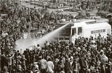  ?? Associated Press ?? Police fire water into a crowd protesting the military coup in the capital of Naypyitaw, Myanmar, on Monday.