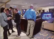  ?? SARAH GORDON/THE DAY ?? Republican­s watch results on a TV in the lobby during an election night event for gubernator­ial candidate Bob Stefanowsk­i at the Sheraton Hartford South Hotel in Rocky Hill on Tuesday.